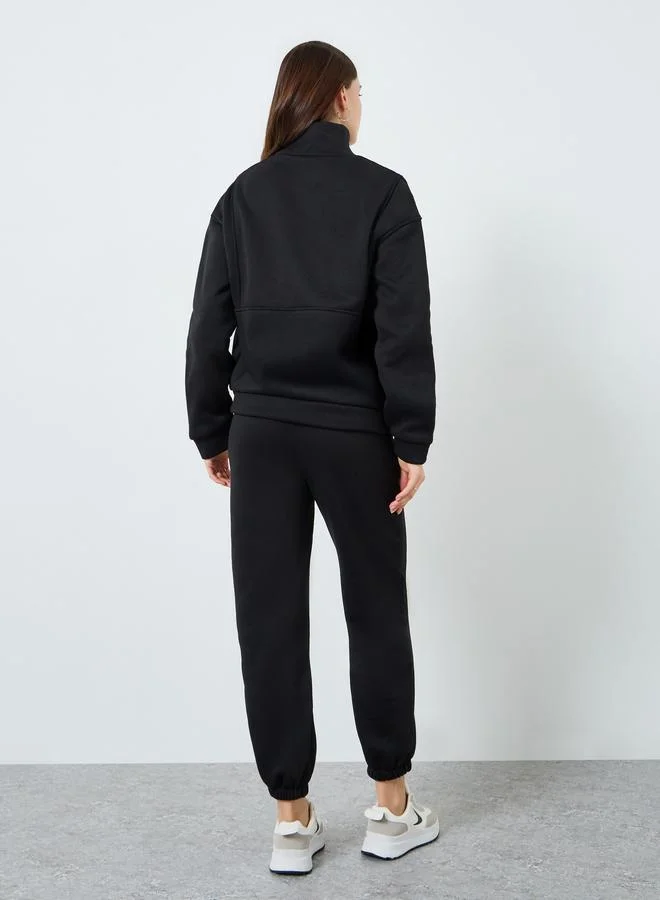 ستايلي طقم بلوزة بسحاب وبنطلون رياضي مضلع