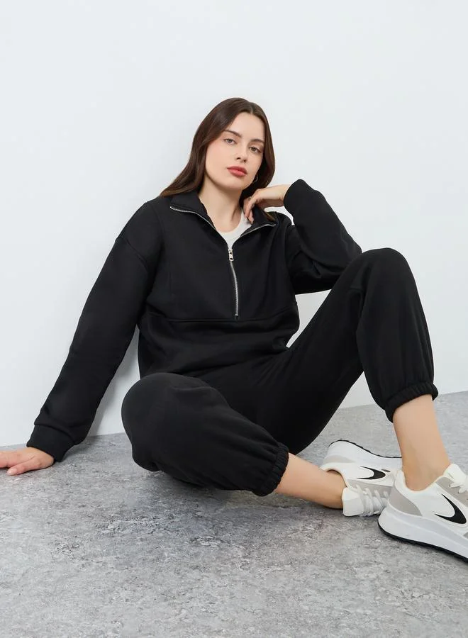 ستايلي طقم بلوزة بسحاب وبنطلون رياضي مضلع