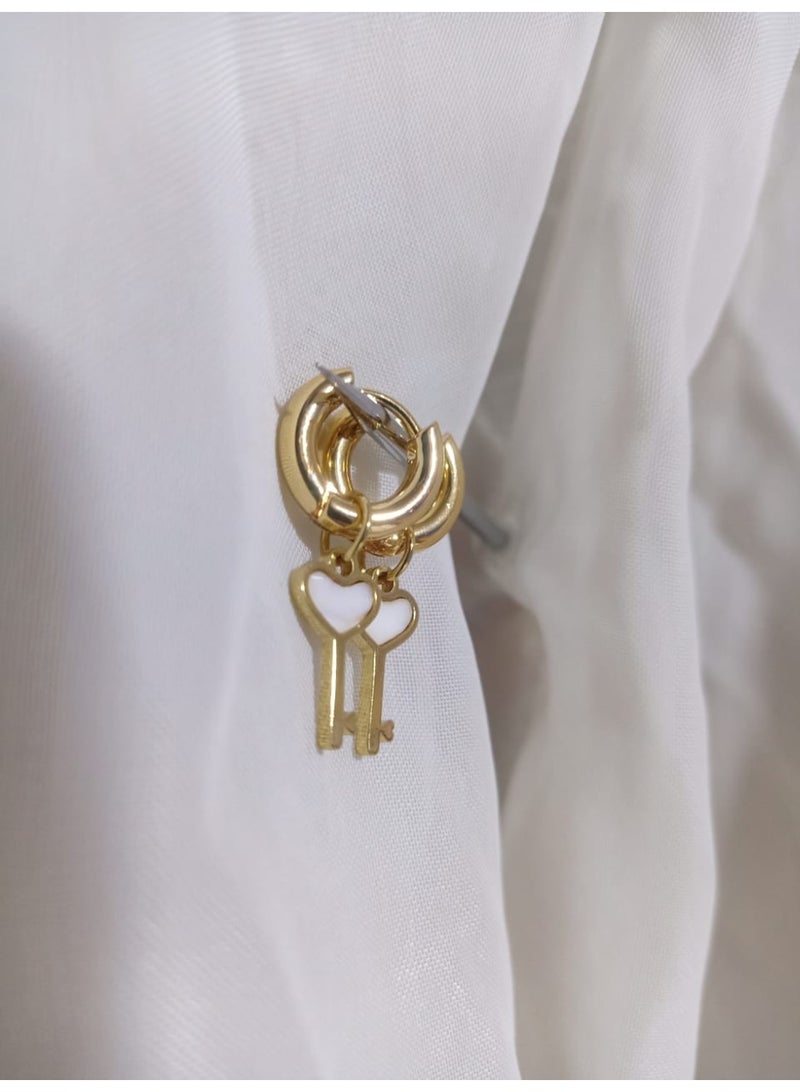 Luxuria Gold-plated hoop earrings with a key design adorned with a white heart. These earrings are also known as "heart key earrings". - Image 2