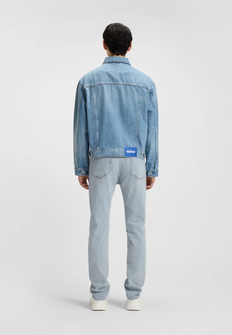 هوجو جينز بقصة ضيقة من الدنيم الأزرق المغسول