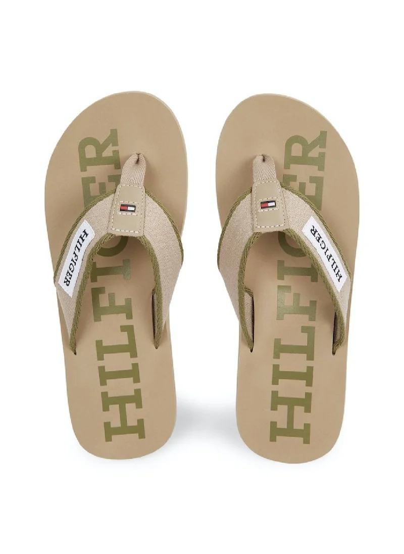 TOMMY HILFIGER Men's Hilfiger Monotype Webbing Strap Flip-Flops -  Polyester webbing upper, Beige