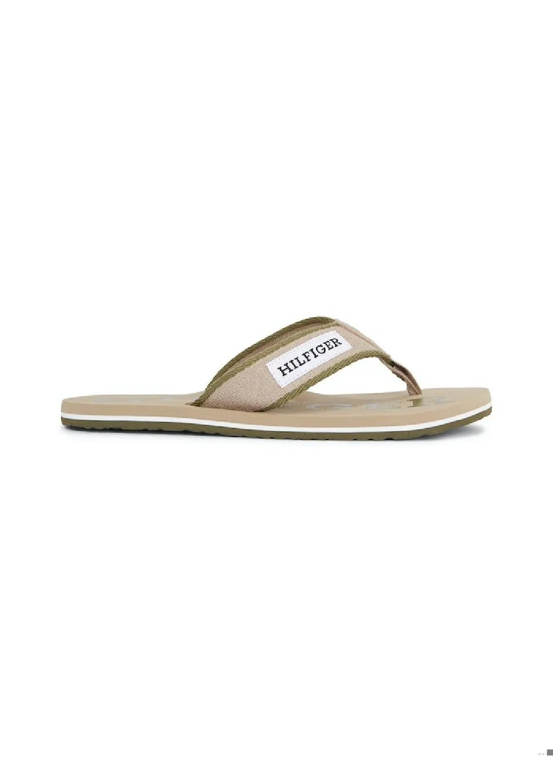 TOMMY HILFIGER Men's Hilfiger Monotype Webbing Strap Flip-Flops -  Polyester webbing upper, Beige