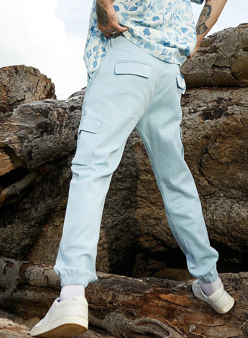 Campus Sutra Men's Light Blue Cuffed Hem Cargo Trousers For Casual Wear | 6 Pockets | Regular Fit | Button Closure | Cotton Poly Cargo Pant Crafted With Comfort Fit For Everyday Wear