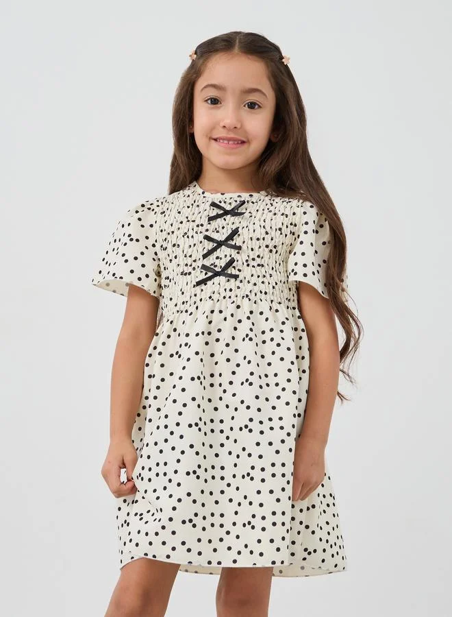 ستايلي Styli Girls Off White All-Over Print Smocked A-Line Dress with Bow Detail