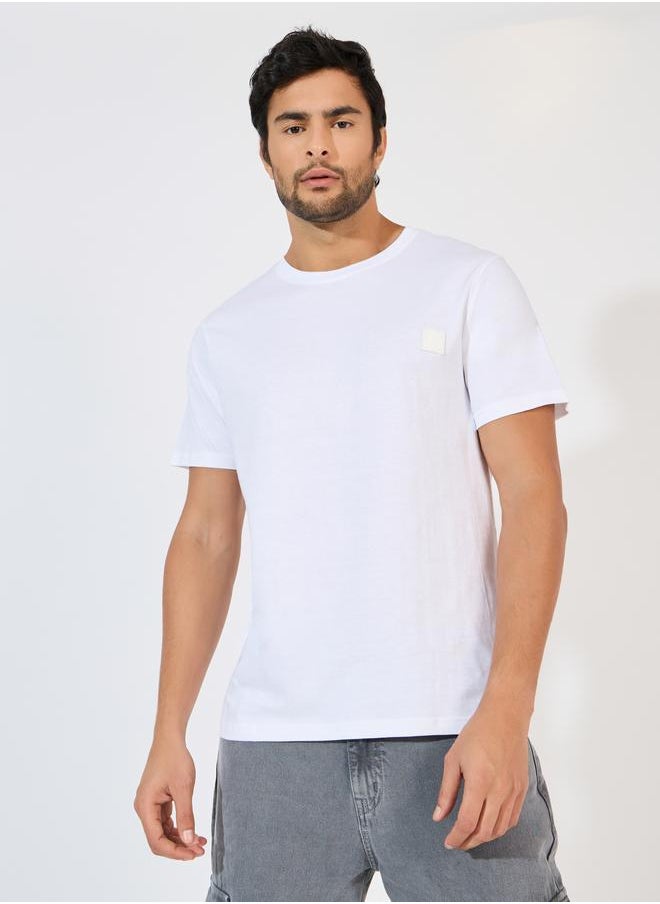 Styli Styli Crew Neck Regular Fit T-Shirt with Silicon Badge  - Image 1