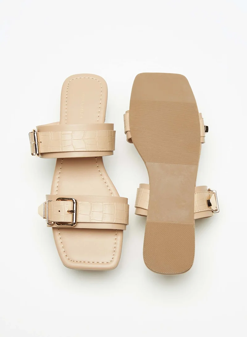 فلورا بيلا من شو إكسبرس Womens Textured Slip-On Dual Strap Slide Sandals with Buckle Accent