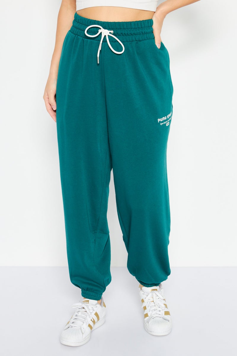 PUMA Women Relaxed Fit Embroidered Outdoor Sweatpants, Green - Image 1