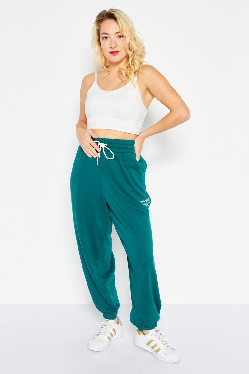 PUMA Women Relaxed Fit Embroidered Outdoor Sweatpants, Green - Image 4