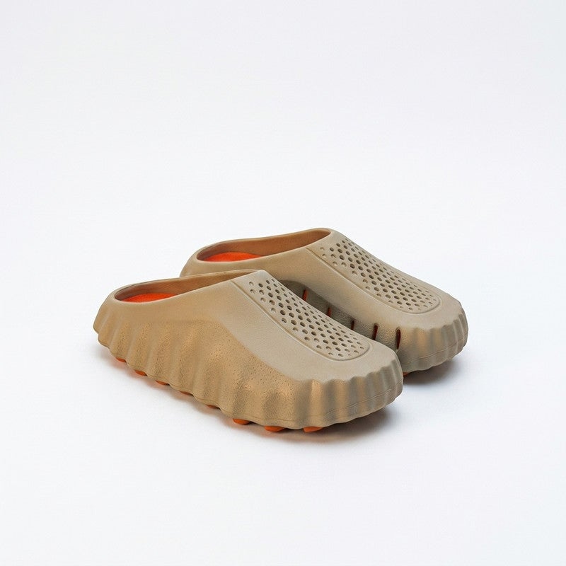 A sleek and comfortable closed-toe slide sandal designed with a unique wave-textured side profile and top ventilation holes, ensuring maximum breathability and cushioned comfort for daily wear.