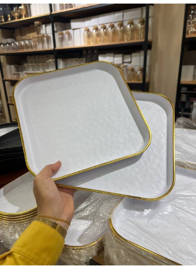 A plate with a gilded frame that can also be used as a serving tray. Made of plastic.