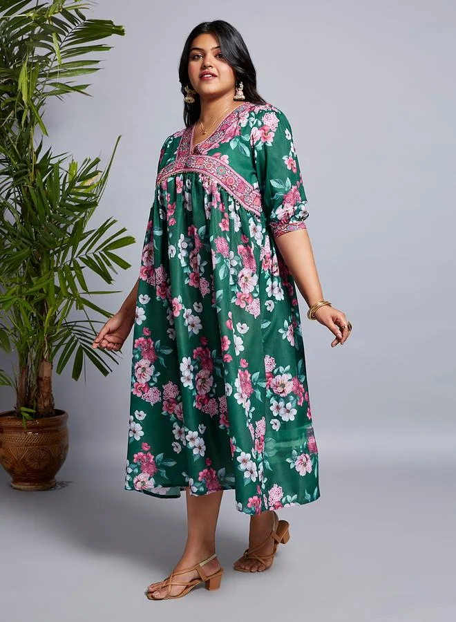 جلو باص فستان ميدي بمقاس كبير مطبع بطبعة زهور