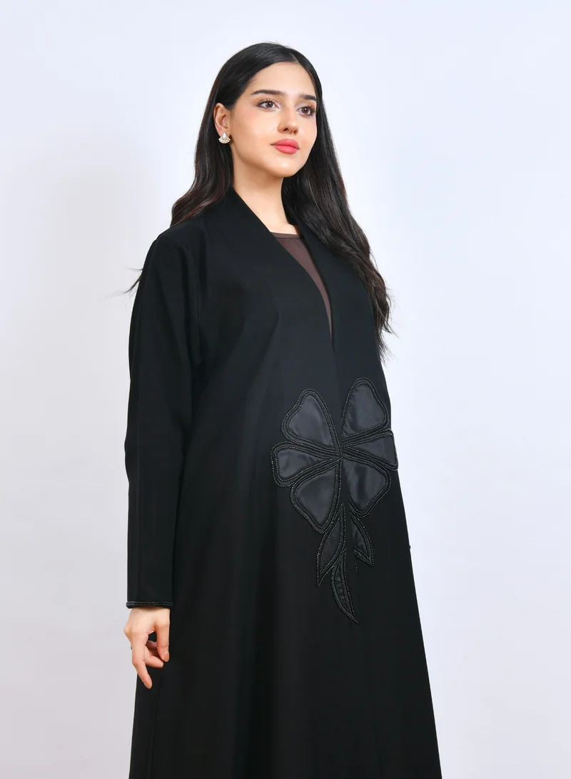 HAWRAA ABAYA Luxurious black abaya with a stylish modern design, featuring prominent flower embroidery decorated with shawl cut.