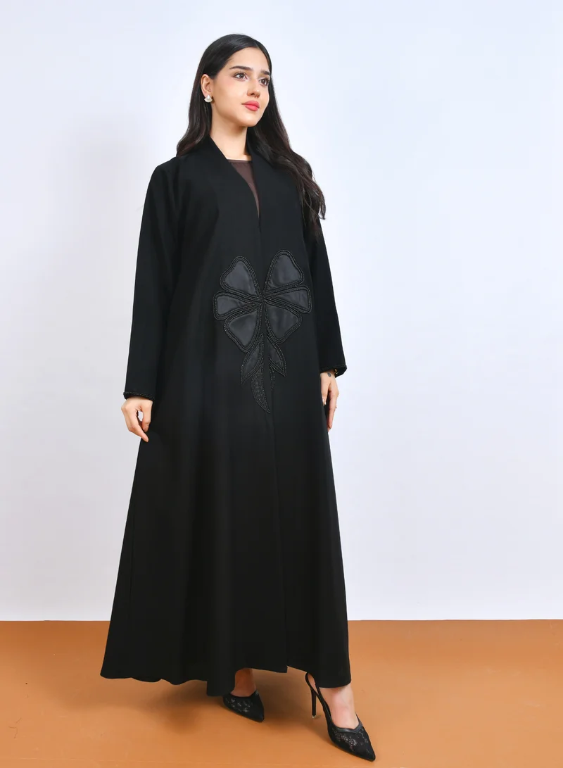 HAWRAA ABAYA Luxurious black abaya with a stylish modern design, featuring prominent flower embroidery decorated with shawl cut.
