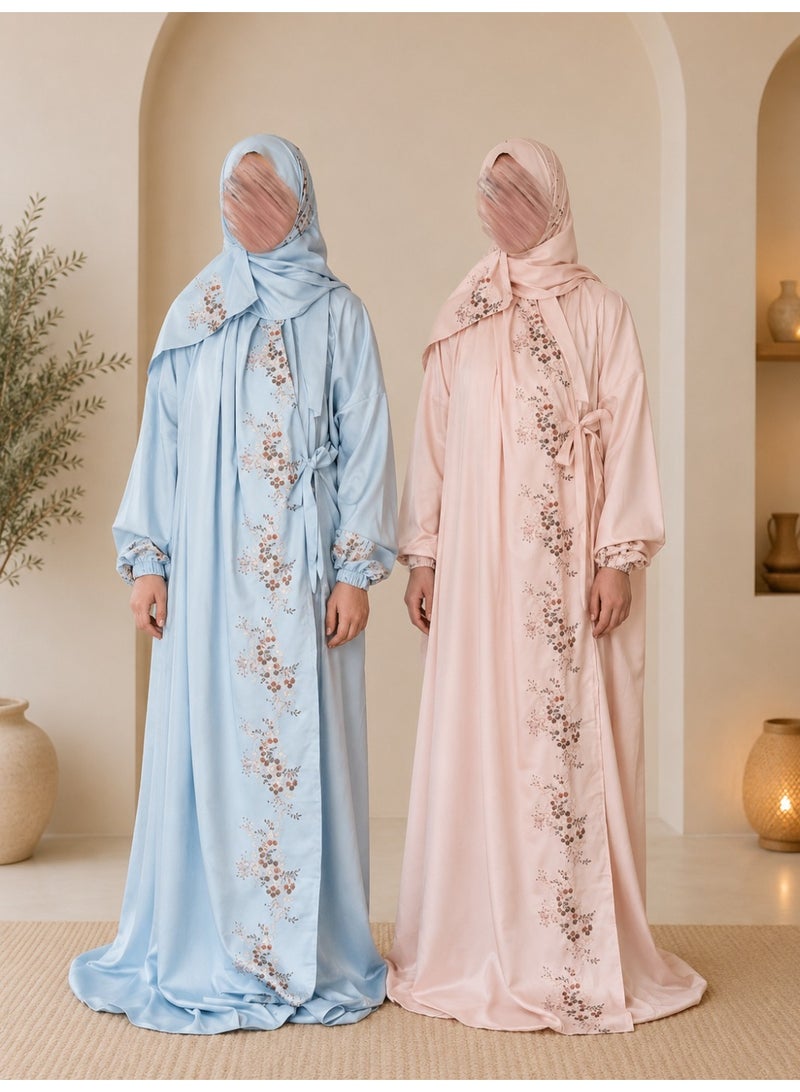 A two-piece women's prayer set featuring elegant embroidery and soft, comfortable fabric; it includes an attached head covering and a loose-fitting design that provides full coverage during prayer.