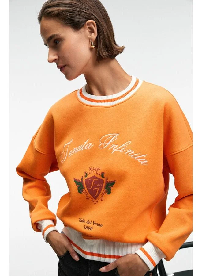 GRIMELANGE VALLUNE Women's Contrast Knit Skirt Edge Sleeve and Collar Embroidered Crop Orange Sweatshirt.