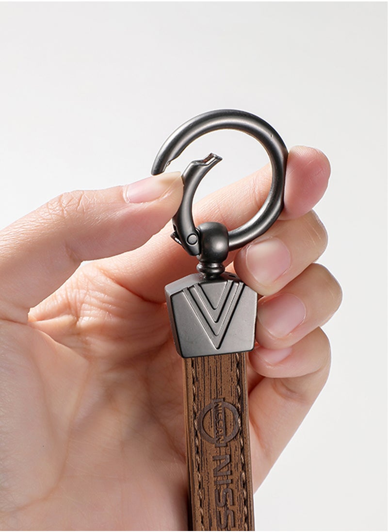 Elegant light brown metal and leather keychain with NISSAN logo featuring 3 key rings perfect as a fancy gift or car accessory designed in sleek light brown for a modern look offers 360 degree rotation for convenience suitable for both men and women and comes in a gift box.