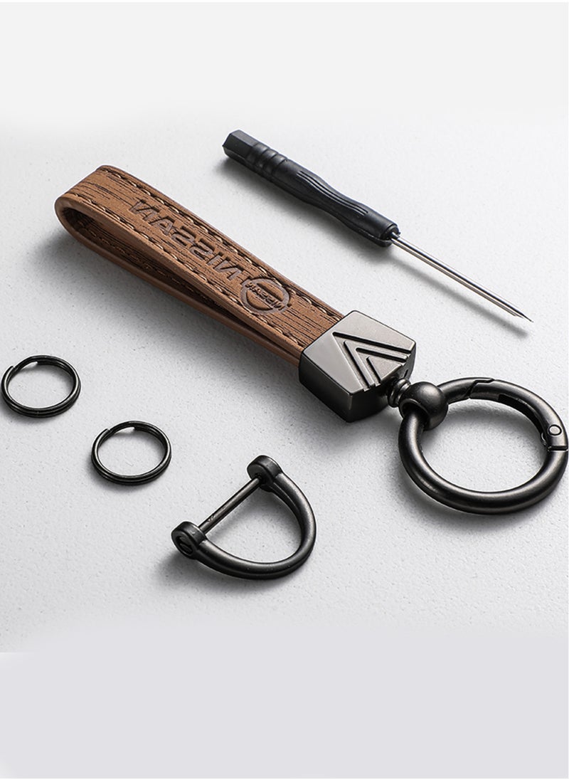 Elegant light brown metal and leather keychain with NISSAN logo featuring 3 key rings perfect as a fancy gift or car accessory designed in sleek light brown for a modern look offers 360 degree rotation for convenience suitable for both men and women and comes in a gift box.