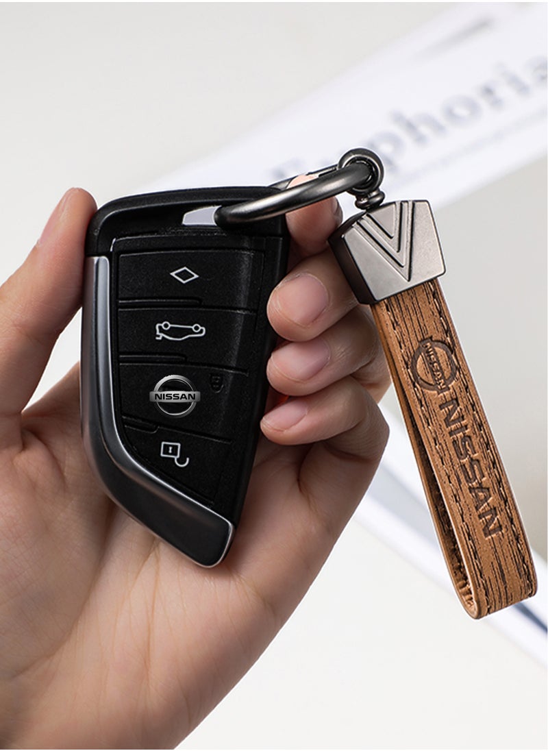 Elegant light brown metal and leather keychain with NISSAN logo featuring 3 key rings perfect as a fancy gift or car accessory designed in sleek light brown for a modern look offers 360 degree rotation for convenience suitable for both men and women and comes in a gift box.