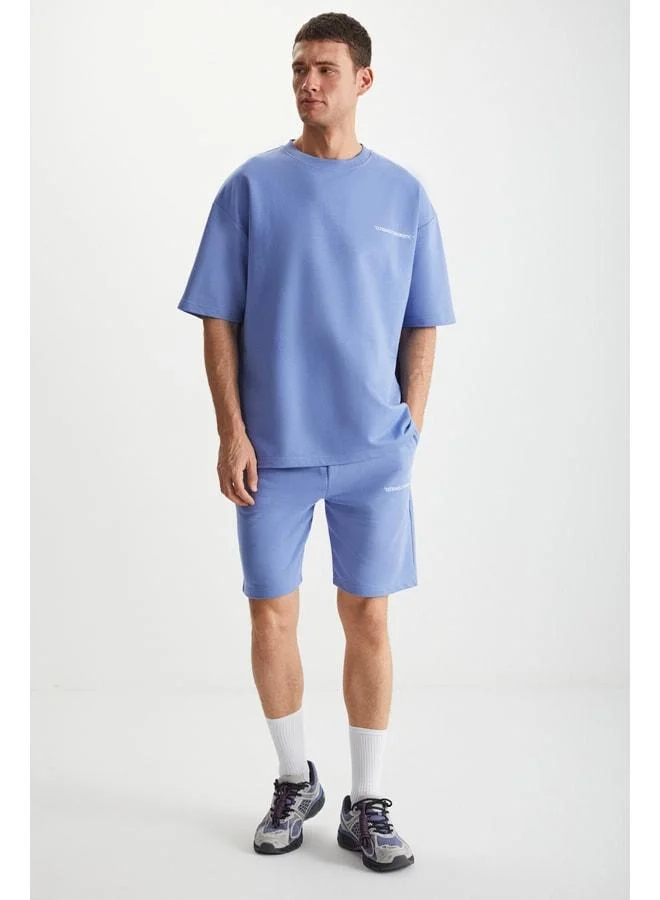 جريميلانج طقم رجالي من كولومبيا مكوّن من قطعتين بتصميم مريح (Comfort Fit) وقصّة مريحة، مطبوع ومطرّز، بدون شاردون، باللون الأزرق.