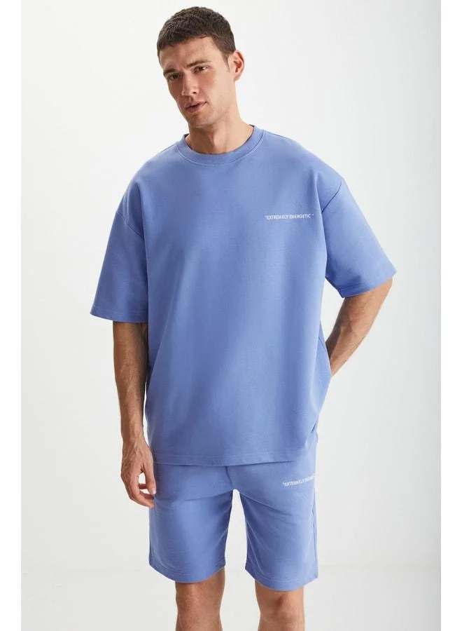 جريميلانج طقم رجالي من كولومبيا مكوّن من قطعتين بتصميم مريح (Comfort Fit) وقصّة مريحة، مطبوع ومطرّز، بدون شاردون، باللون الأزرق.