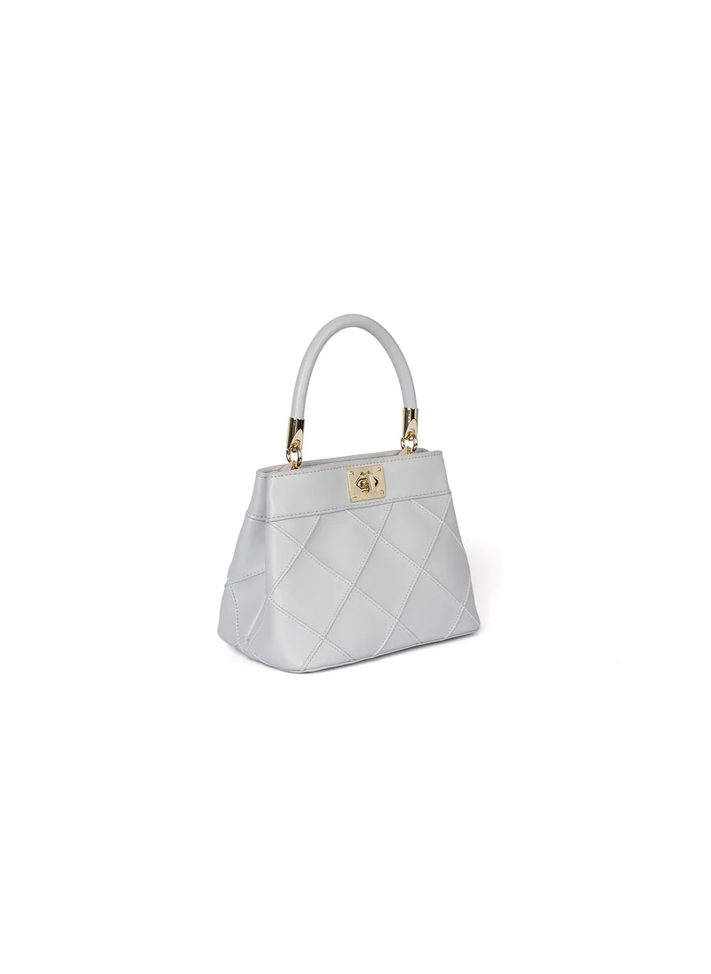 كابلي Quilted handbag with a gold clasp and handle