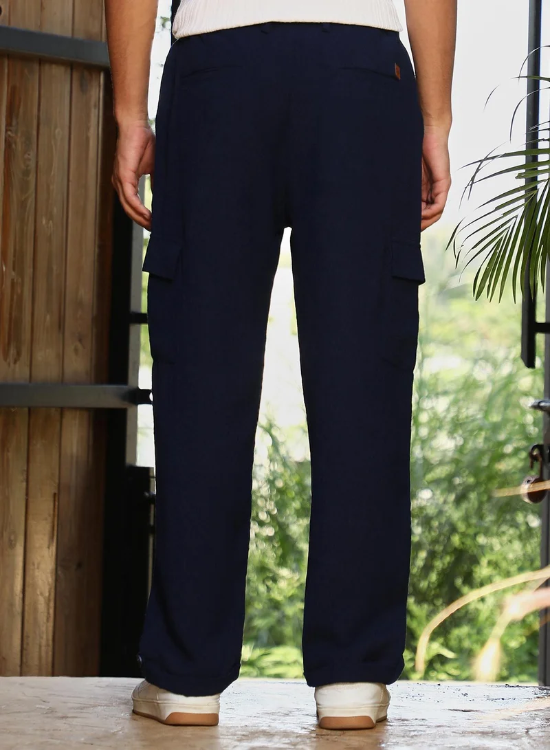 Campus Sutra  Men Pleated-Textured Cargo Trousers | Mid-Rise , Side Elasticated Stretch Waist | Button , Cuffed-Straight Hem | Solid Textured | Woven Fabric For Casual & Street Wear | Navy Blue for Men | Best Price UAE