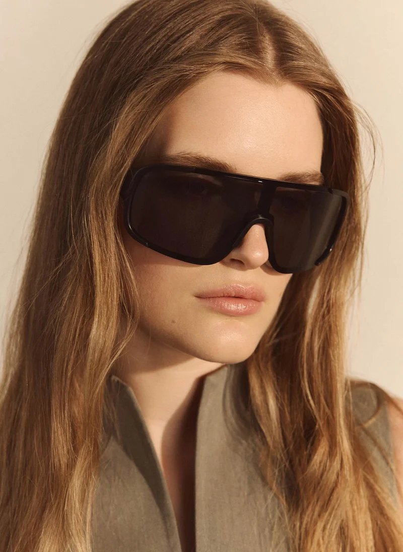 Goggle-style sunglasses with semi-transparent lenses