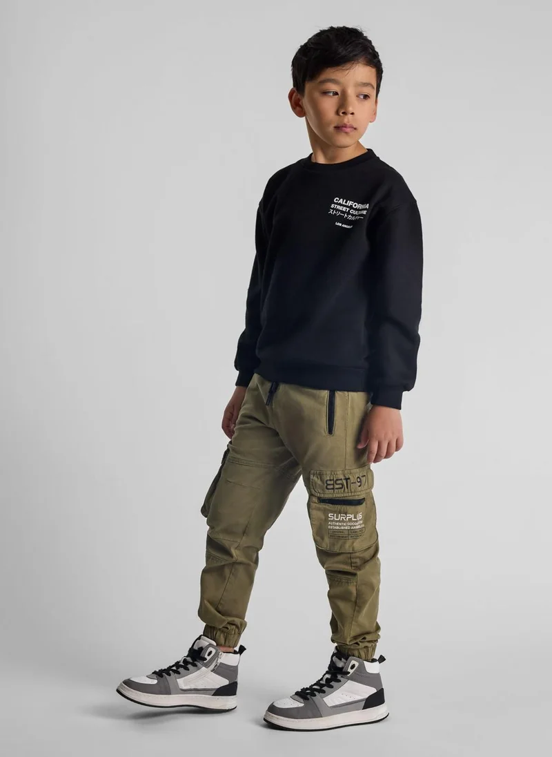 MINOTI Teen Boys Cargo Trousers with Zipped Pockets and a Print