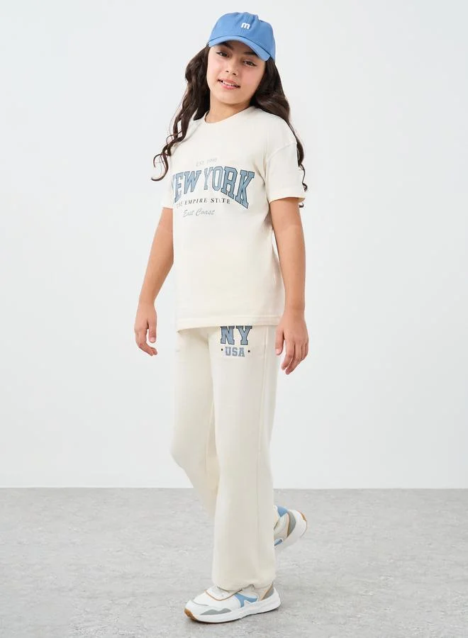 ستايلي Styli Girls Off White Slogan Print Oversized T-Shirt and Wide Leg Joggers Set
