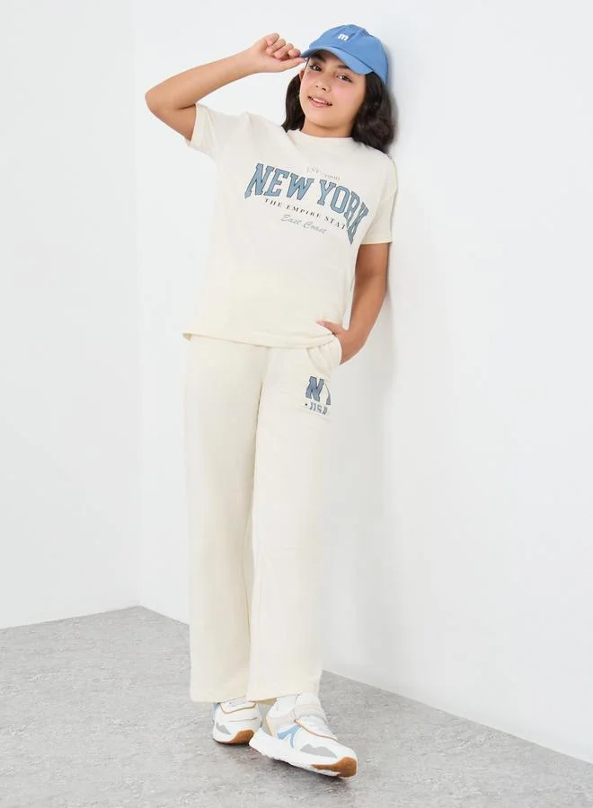 ستايلي Styli Girls Off White Slogan Print Oversized T-Shirt and Wide Leg Joggers Set