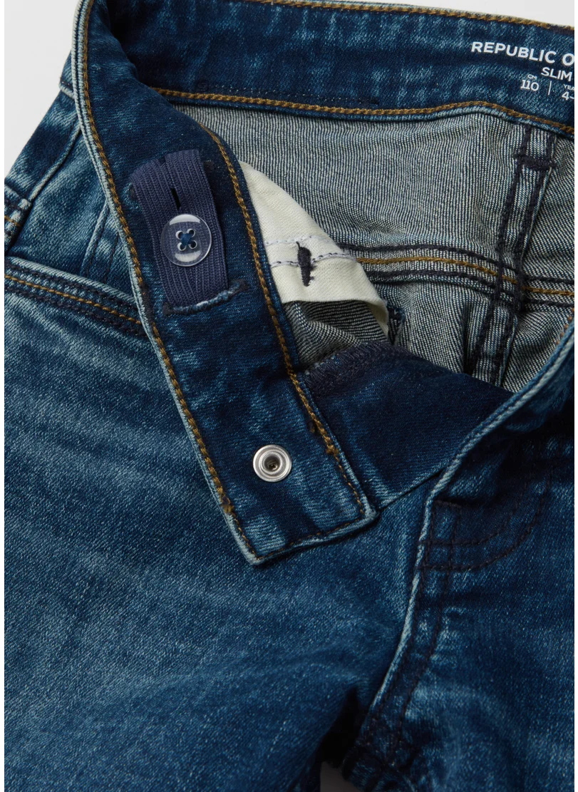 او في اس Slim-fit jeans with five pockets and ''Varsity'' print