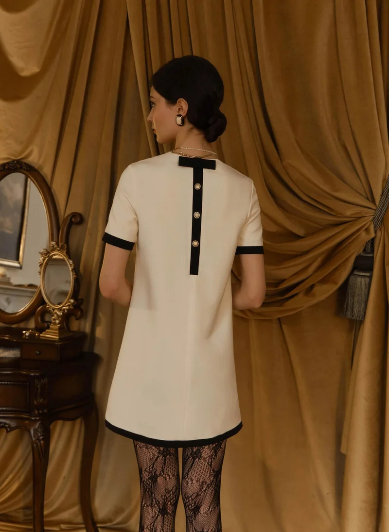 Lichi Mini dress with contrasting details and back decoration