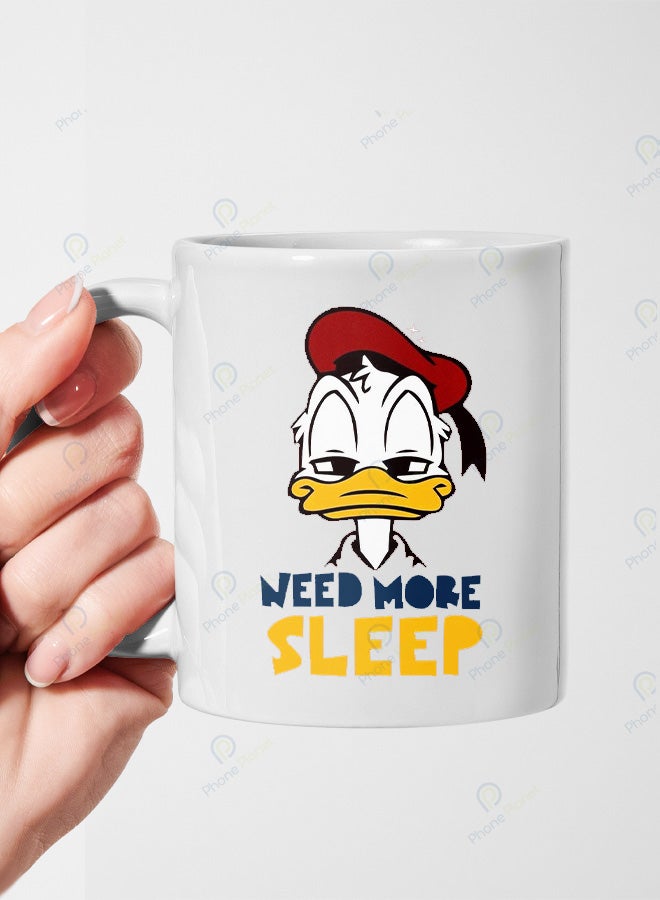 A ceramic mug printed with the phrase I need more sleep and featuring a comfortable handle