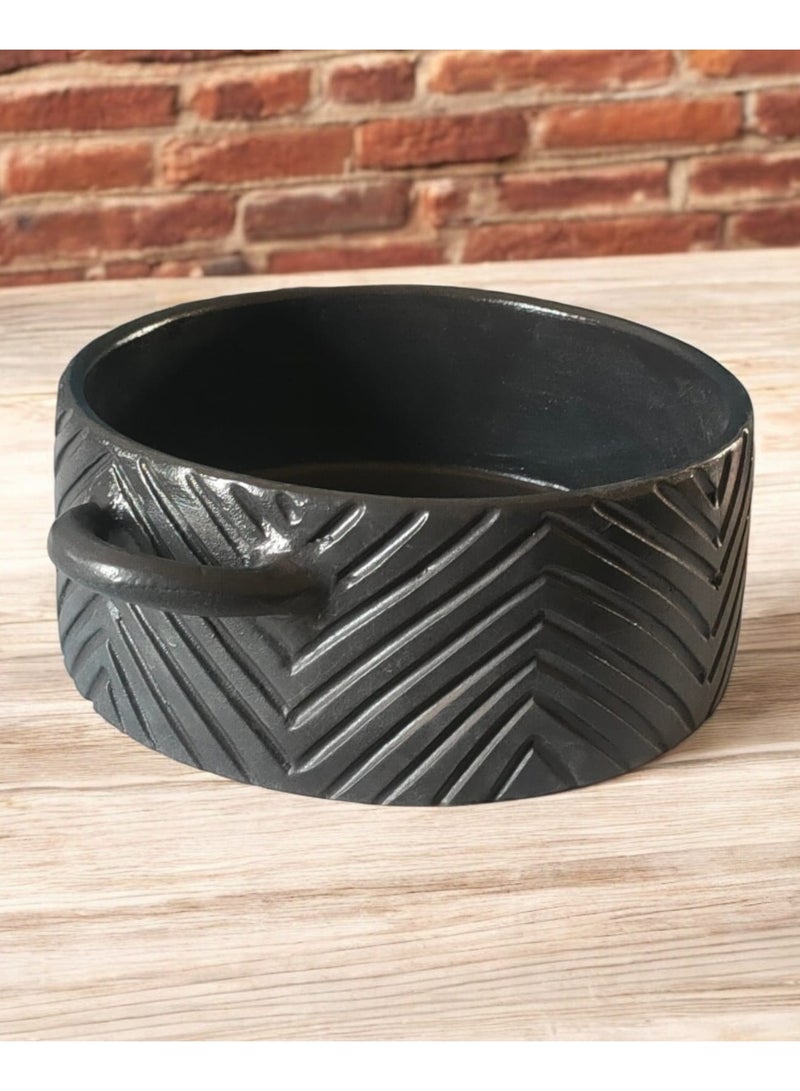 A 27cm black earthenware casserole dish that can withstand direct and indirect heat, suitable for use on a flame or in the oven. - Image 2