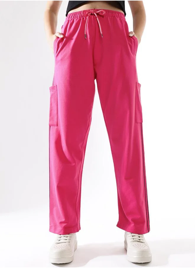 هاي ستار Women Track Pants in Pink featuring Wide Leg fit with a solid pattern, no sleeves, regular length, secured with elasicated + drawstring closure, crafted from terry – a must-have for those who love trendy fashion.
