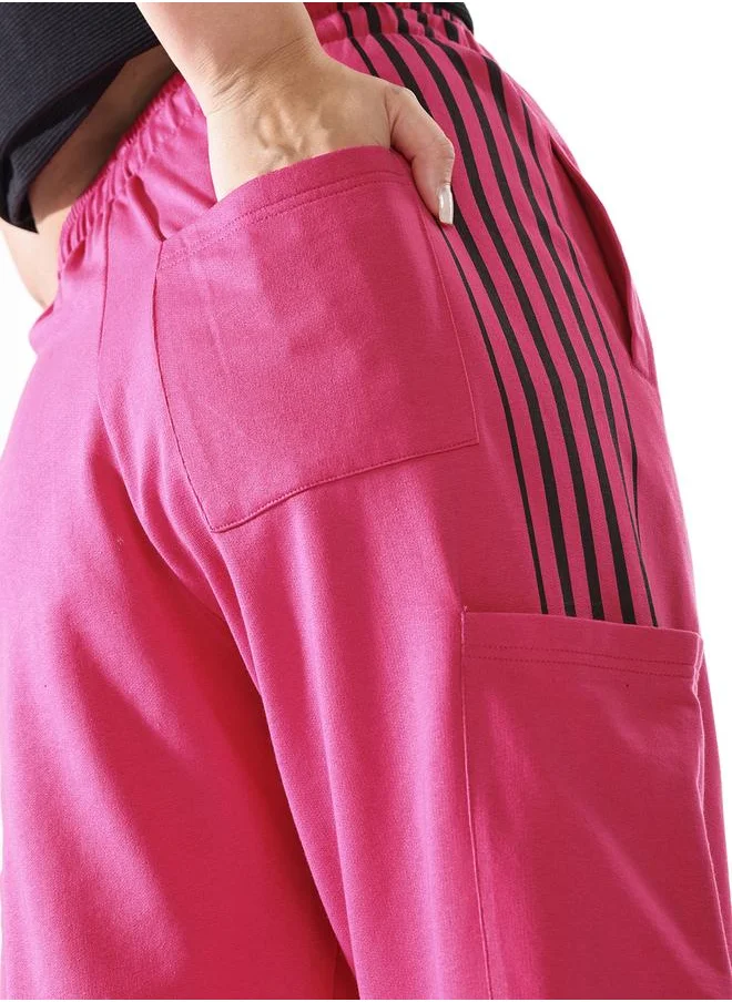 هاي ستار Women Track Pants in Pink featuring Wide Leg fit with a solid pattern, no sleeves, regular length, secured with elasicated + drawstring closure, crafted from terry – a must-have for those who love trendy fashion.