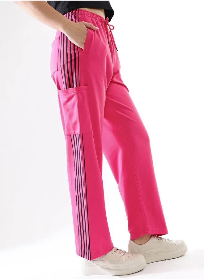هاي ستار Women Track Pants in Pink featuring Wide Leg fit with a solid pattern, no sleeves, regular length, secured with elasicated + drawstring closure, crafted from terry – a must-have for those who love trendy fashion.