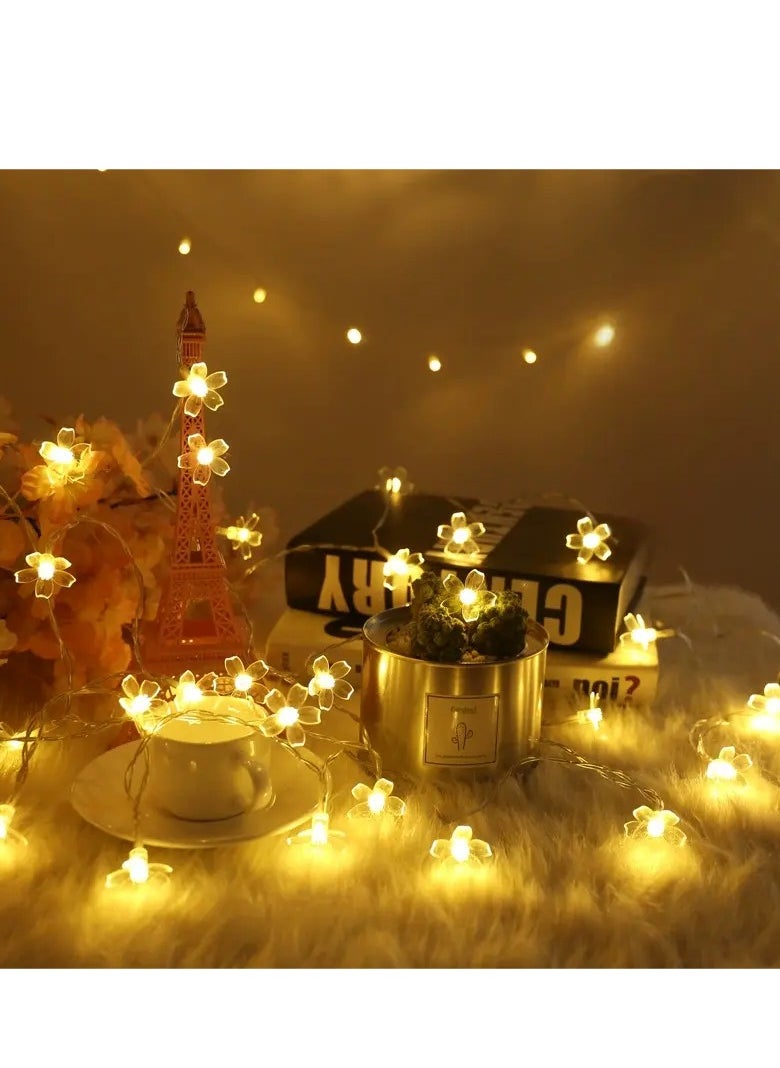 واحة المنزل الجميلة - سلسلة أضواء زهر الكرز ساكورا 3M 20 LED - أبيض دافئ، تعمل بالبطارية (2 × AA)، إضاءة ثابتة، أضواء خرافية زهرية 3 سم لغرفة النوم والحفلات وحفلات الزفاف والديكور الداخلي - Image 1