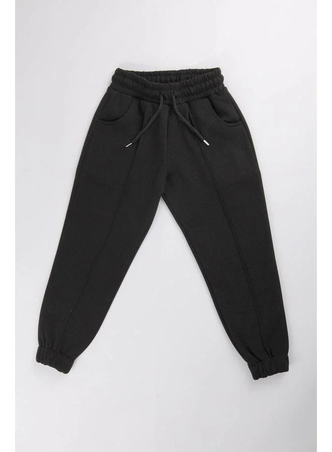 Perendi Black Unisex Kids Sweatpants with Elastic Waist, Fleece Lining, and Pocket.