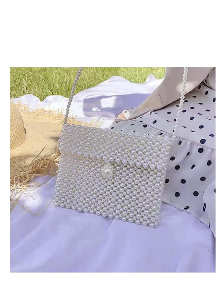 White hand-embroidered women's handbag with a large twist lock