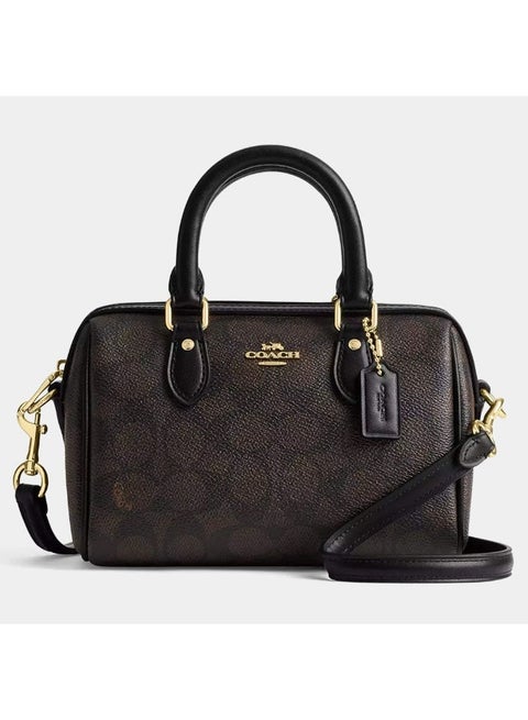 Coach Mini Rowan Crossbody bag in signature coated canvas with brown leather accents.