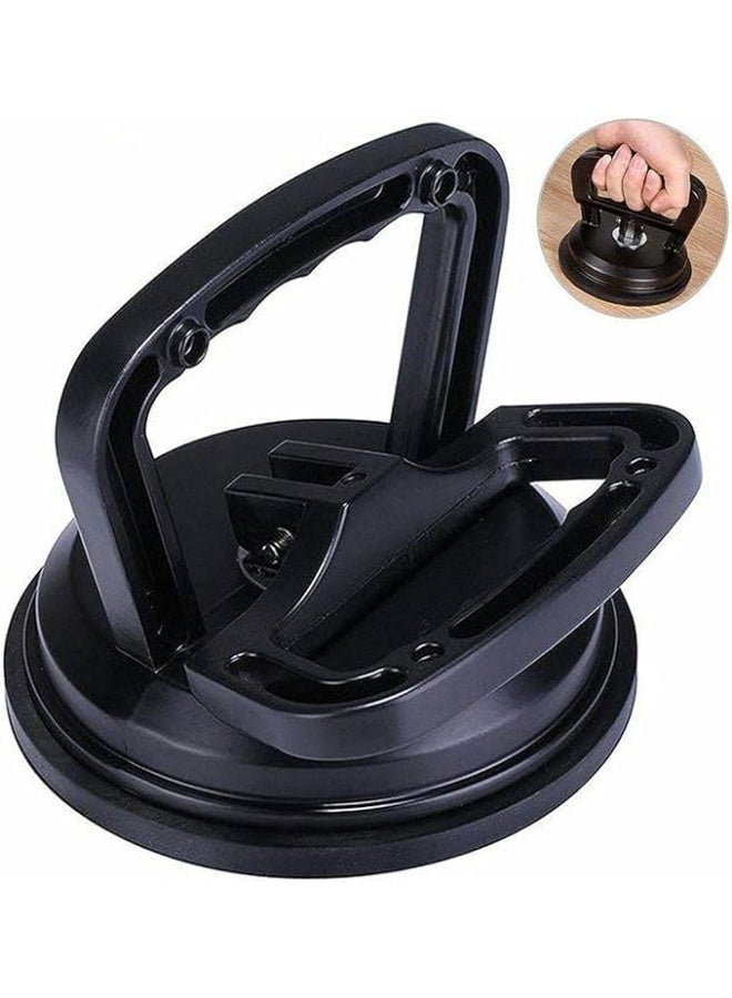 A large-scale car dent repair tool with a suction grip, suitable for removing paintless dents from car body panels, glass, mirrors, granite, and tiles. It features a strong grip and is a durable, portable hand tool (black). - Image 1