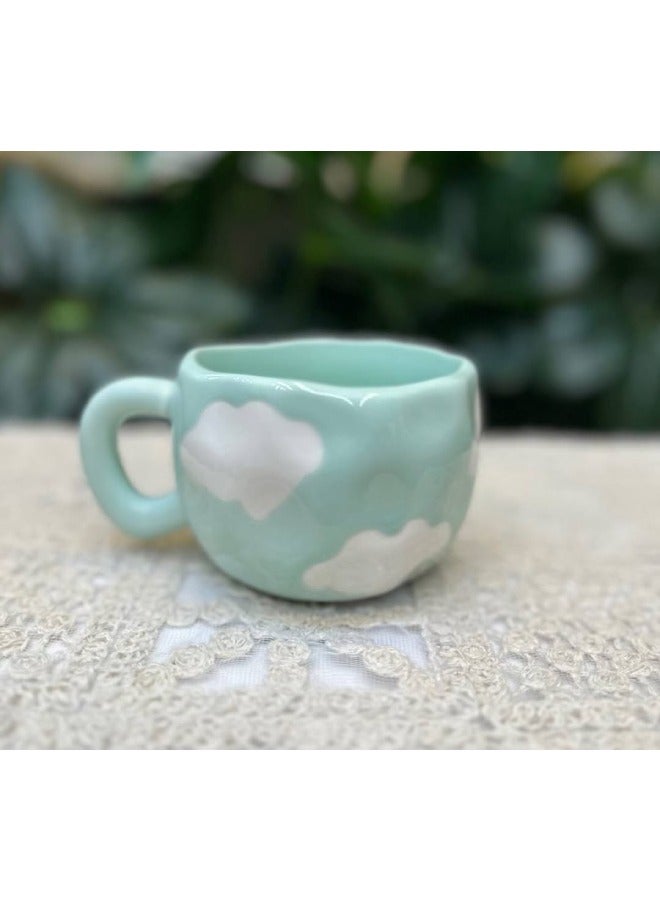 Elegant porcelain mug with a soft green background and cloud print. Perfect for coffee or tea at home or work. Microwave & dishwasher safe. A refined touch with every sip. - Image 1