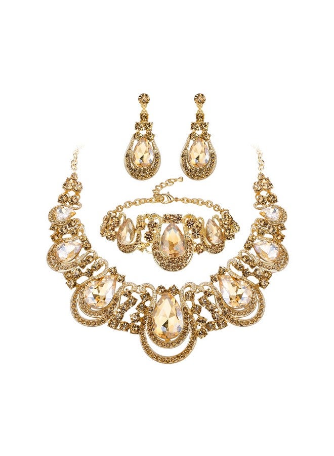 بريلوف طقم مجوهرات نسائي مكون من عقد على شكل دمعة من الكريستال وأقراط متدلية مجوفة وسلسلة وسوار على شكل صدرية لحفلات الزفاف والعروس ووصيفات العروس باللون الذهبي الفاتح - Image 1