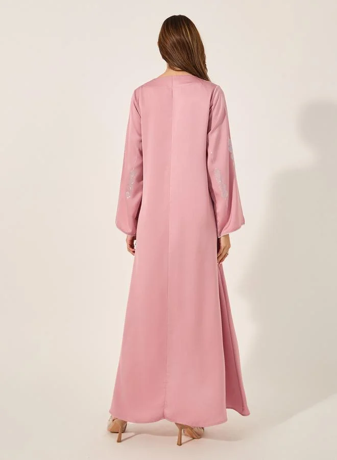 ستايلي matte satin jalabiya with rhinestone pattern embellishment