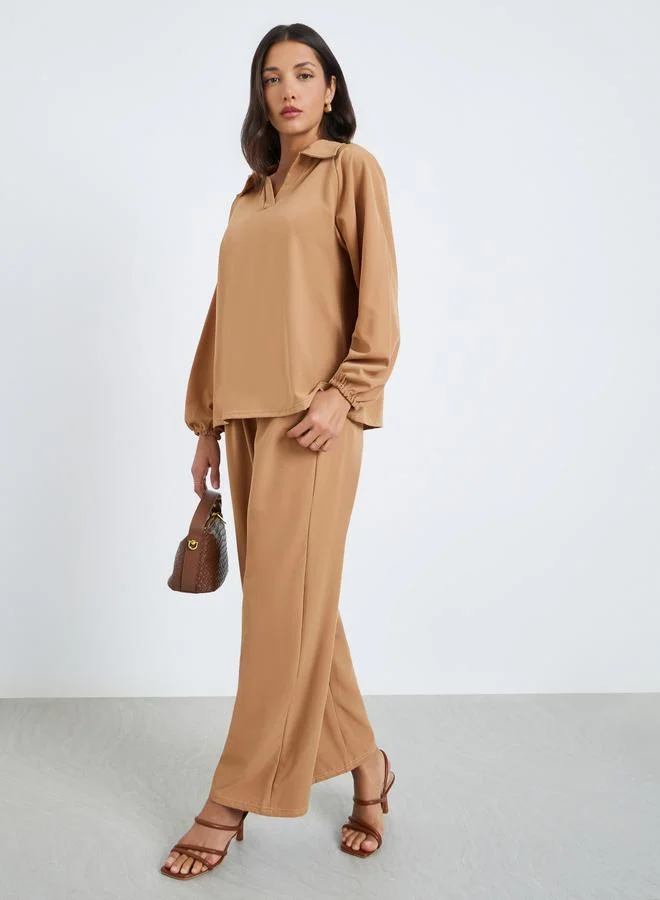 أميرة طقم محتشم من بنطال وبلوزة بياقة قميص وأكمام طويلة