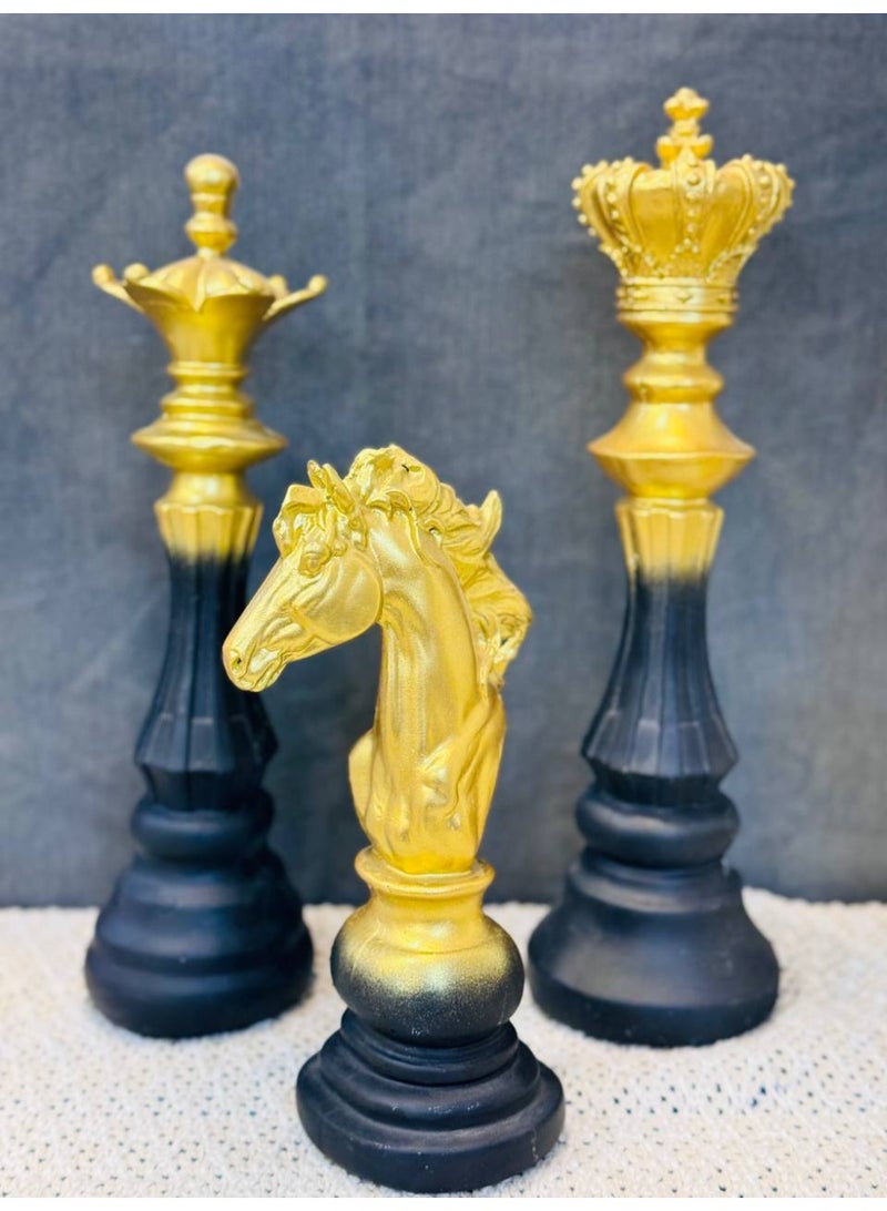 NAMA This Is A Luxurious Chess Set With Large, Meticulously Designed Pieces That Blend Classic And Modern Aesthetics. The Pieces Are Crafted From A High-Quality Resin Material And Feature A Unique Ombré Design That Transitions From A Shiny Gold Finish At The Top To A Matte Black At The Base. The Photo Shows The Knight, Queen, And King, Where The Gold Color Gradually Fades Into Black Towards The Bottom. This Striking Color Contrast Gives The Pieces A Distinctive Artistic Character