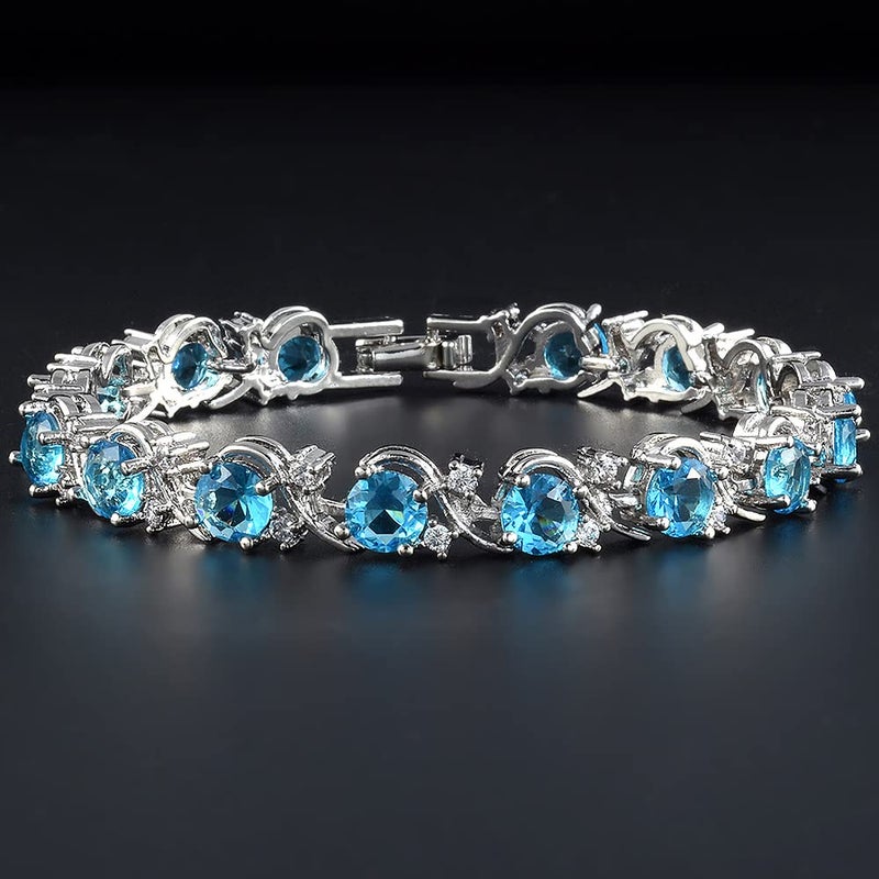 RIZILIA BLOSSOM Tennis Bracelet & Round Cut CZ [6 Colors available] in White Gold Plated, 7" (Blue Topaz) - Image 4