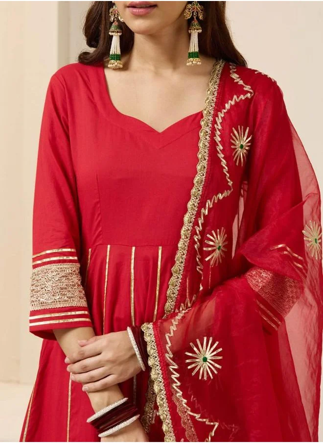 ISHIN Palazzo Women Red Cotton Kurta Set with Embroidered pattern Tunic and Palazzo features a Round neckline and Three-Fourth Sleeve secured with Elastic closure and styled in Straight Fit ideal for Festive moments — exude elegance in every glance.