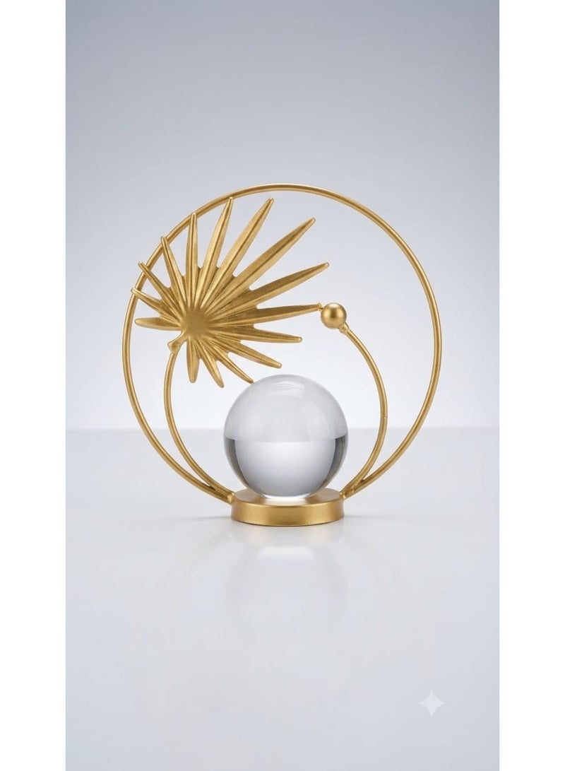 A decorative gold metal ornament with a circular design featuring a leaf and a clear crystal ball - a modern and elegant decoration for tables and shelves. - Image 2
